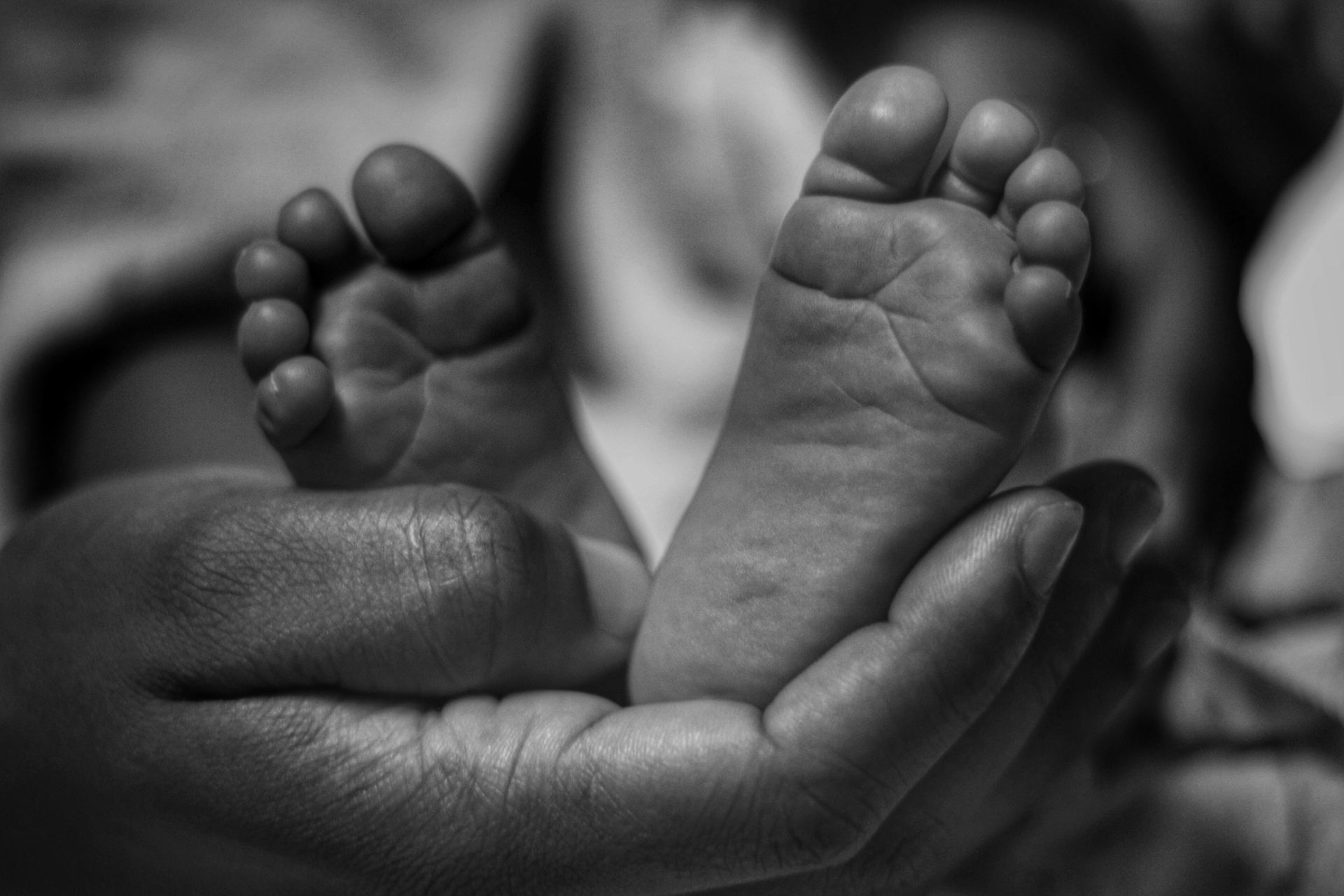 Baby's feet in father's hands