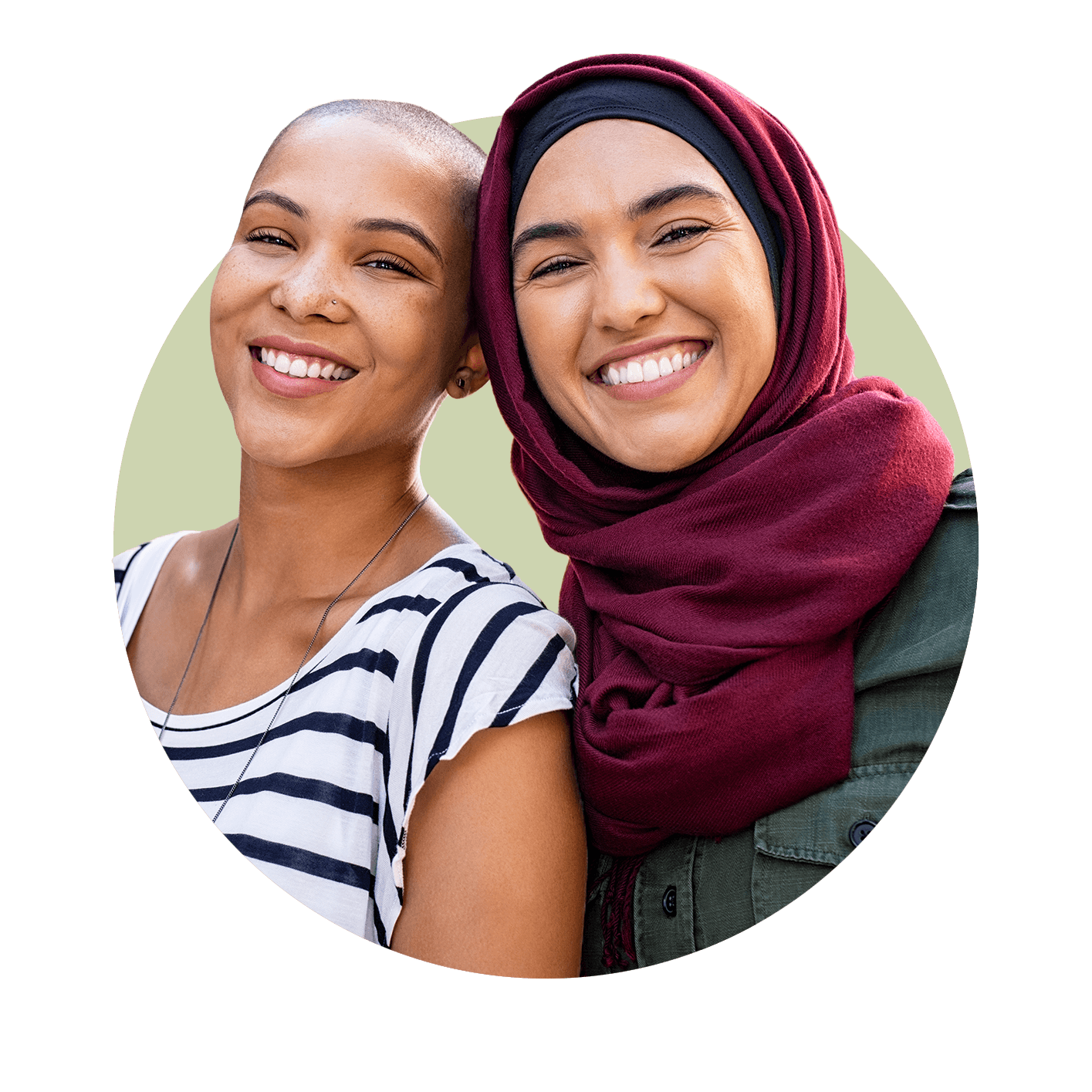 Two multicultural young women with heads touching smiling at camera