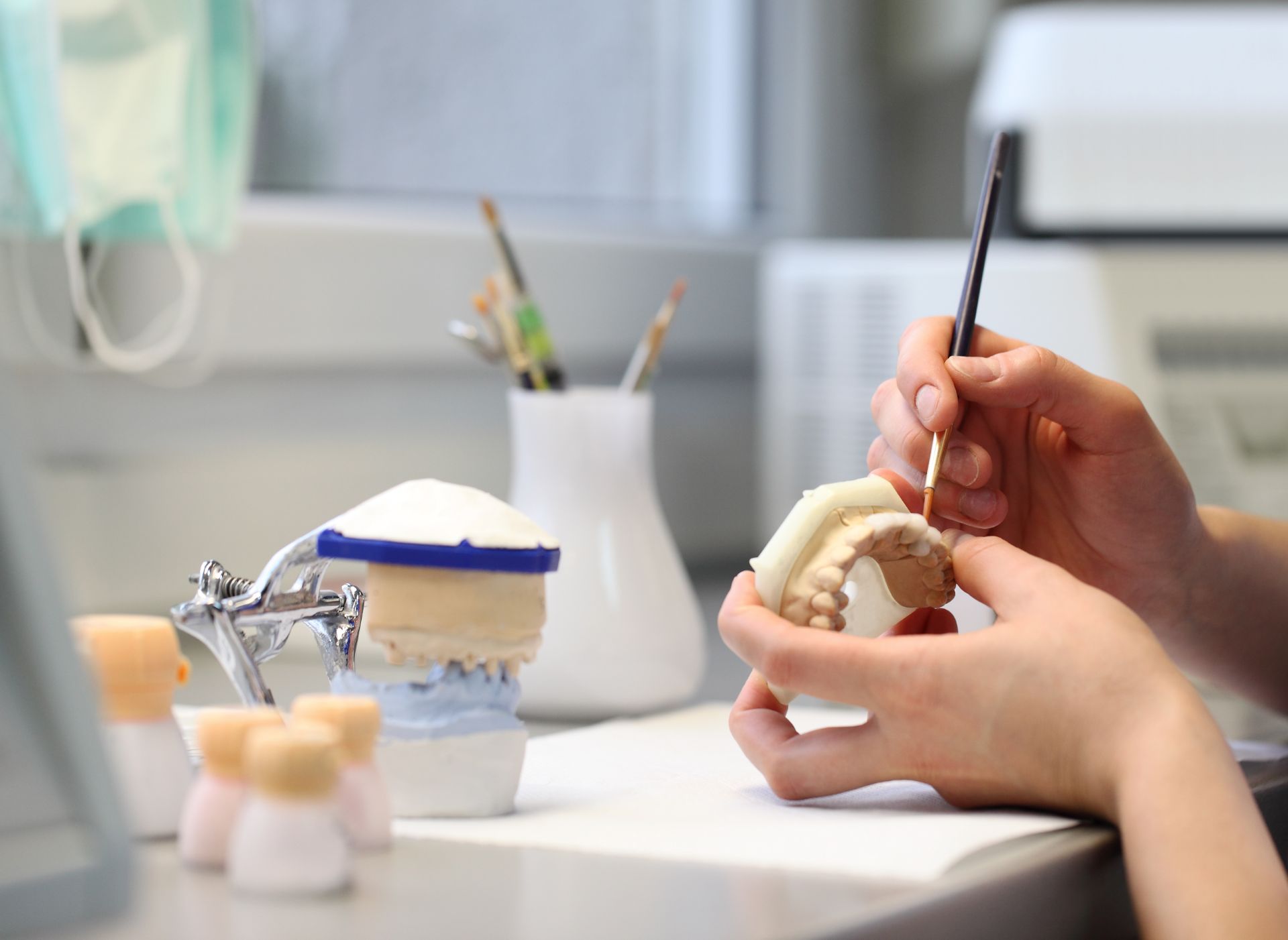 Technician working on model of teeth
