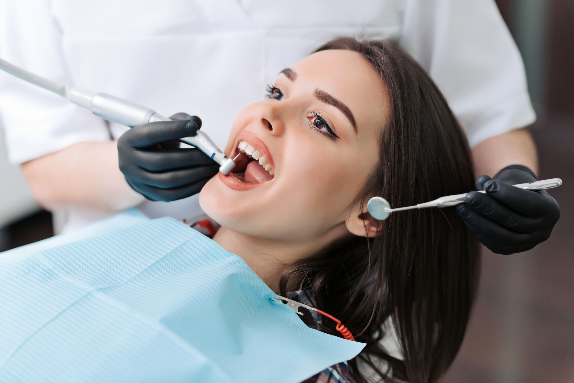 Woman having teeth worked on by dentist