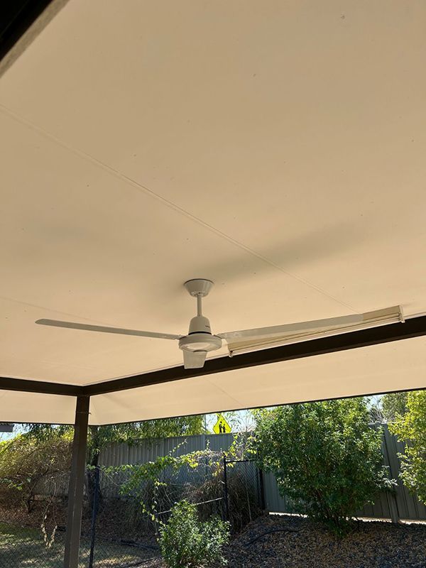 A Ceiling Fan is Hanging From the Ceiling of a Patio Area — AES Electrical Contracting In Winnellie, NT