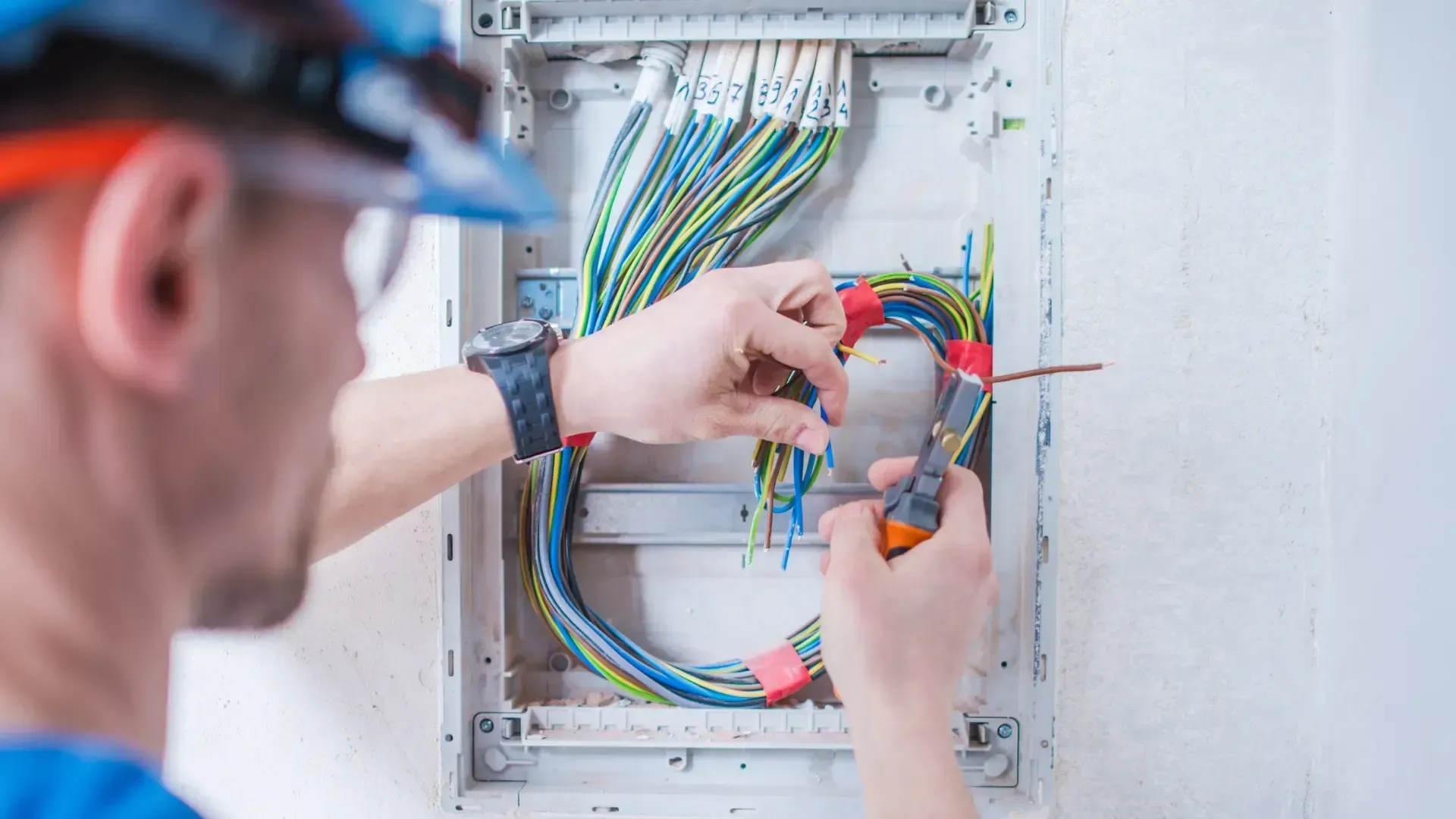An electrician is working on an electrical box.