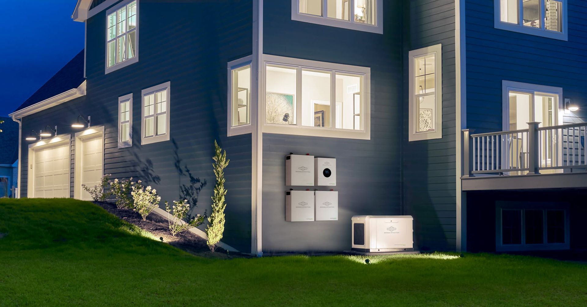A large house with a lot of windows is lit up at night.
