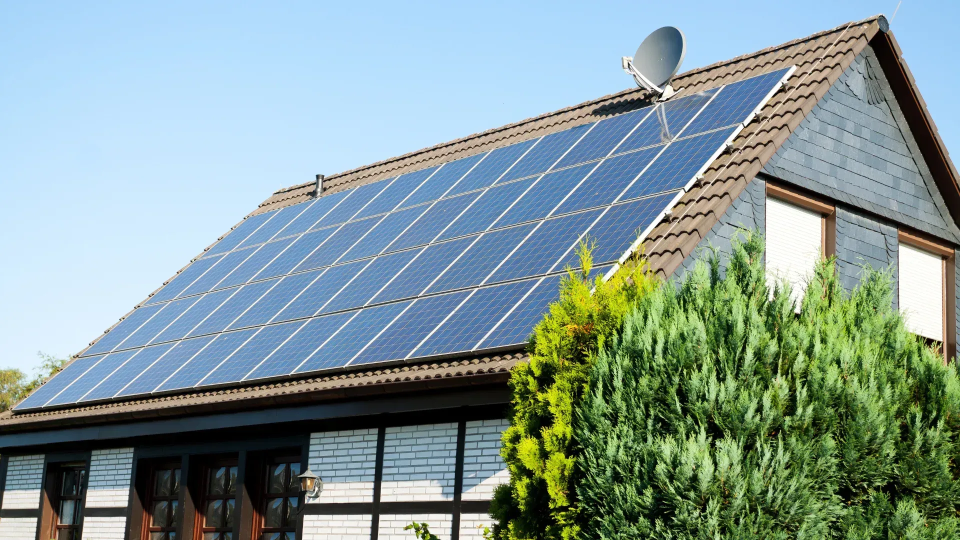 A house with a lot of solar panels on the roof
