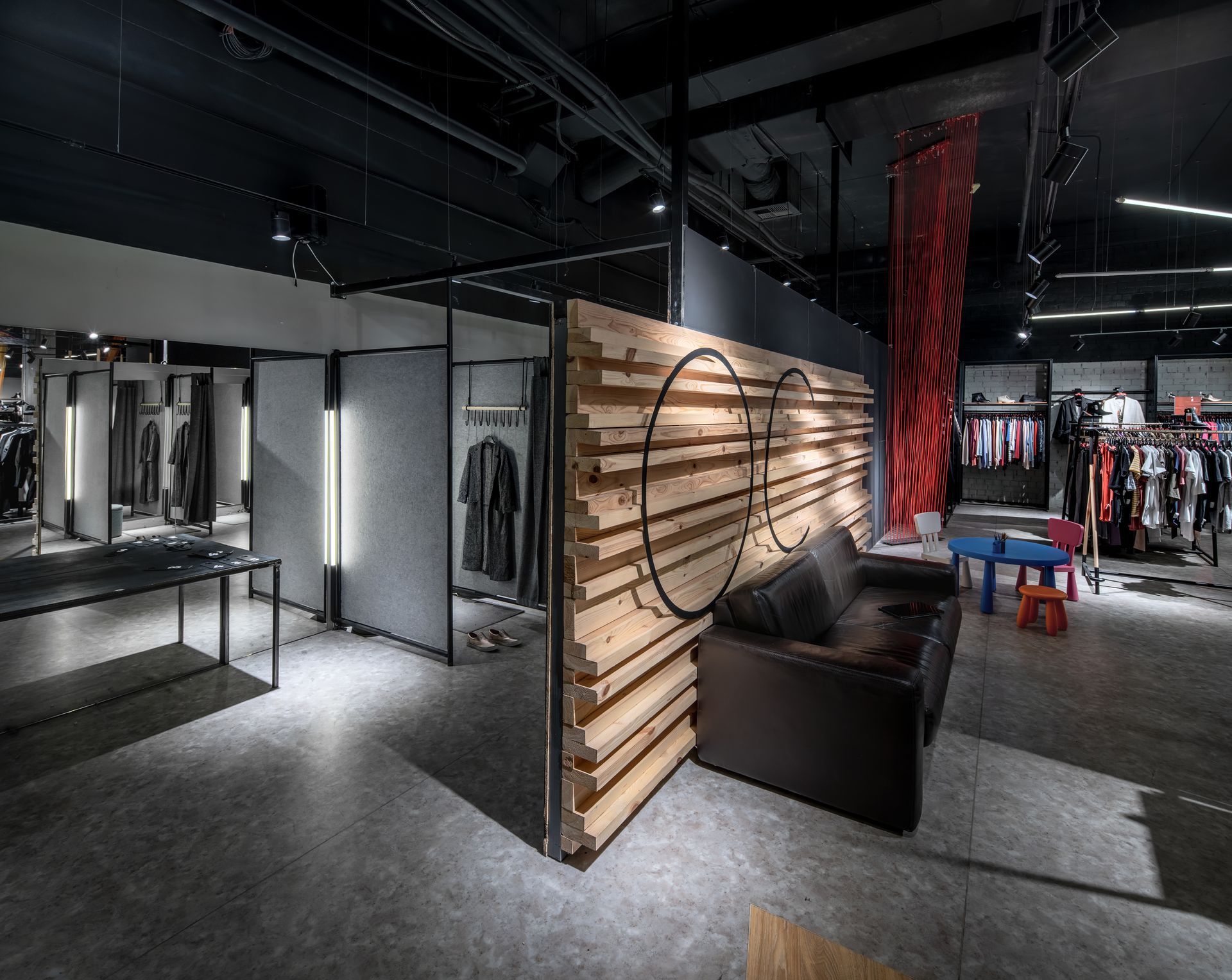 A modern clothing store with a large selection of different wear and shoes, after shop fitting.