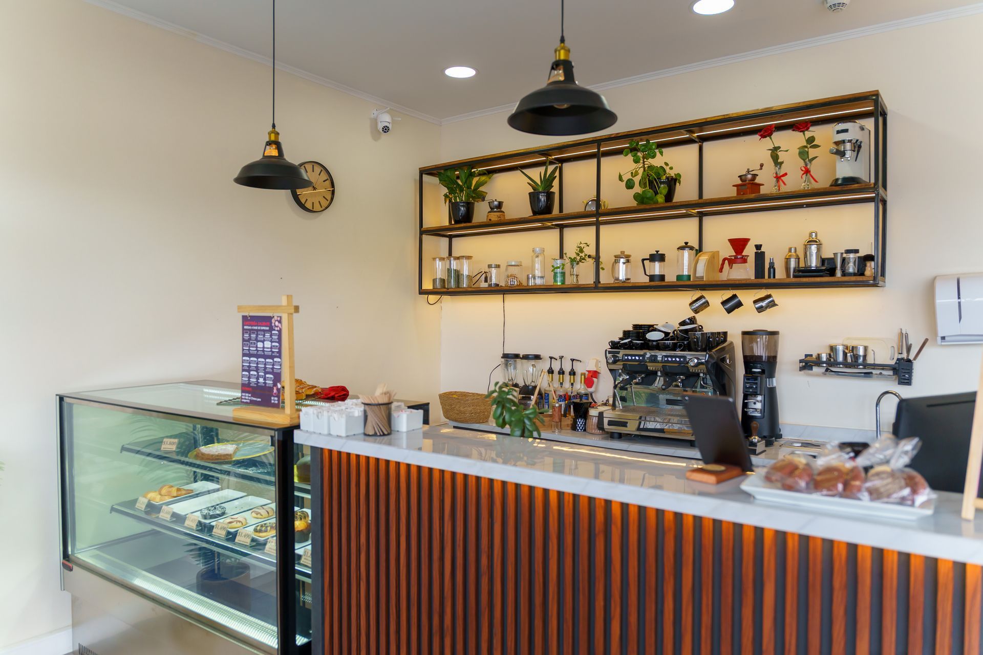 Modern coffee shop counter displaying delicious pastries and beverages.