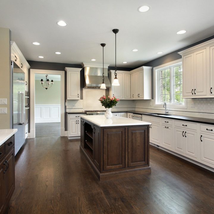 A kitchen with white cabinets and a large island