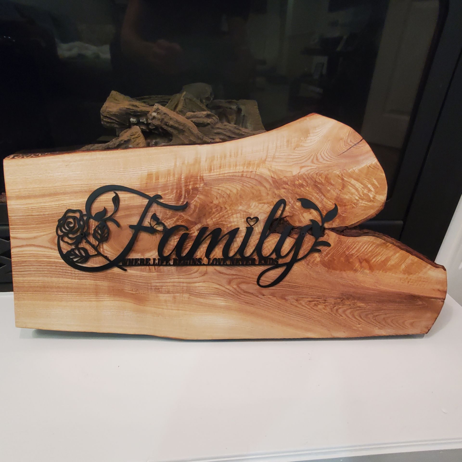 Wood plaque with metal Family text.