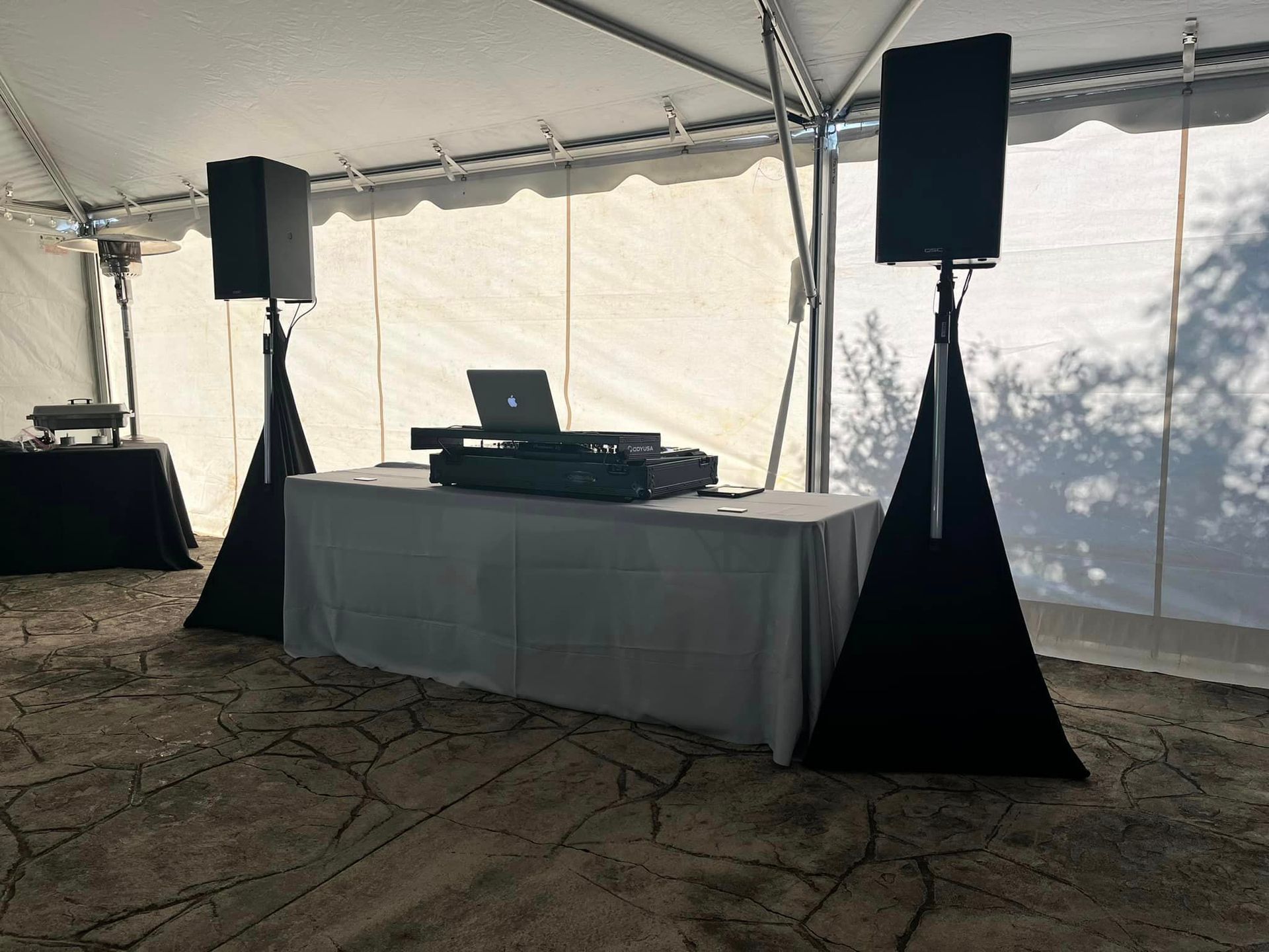 a dj set is sitting on a table under a tent .