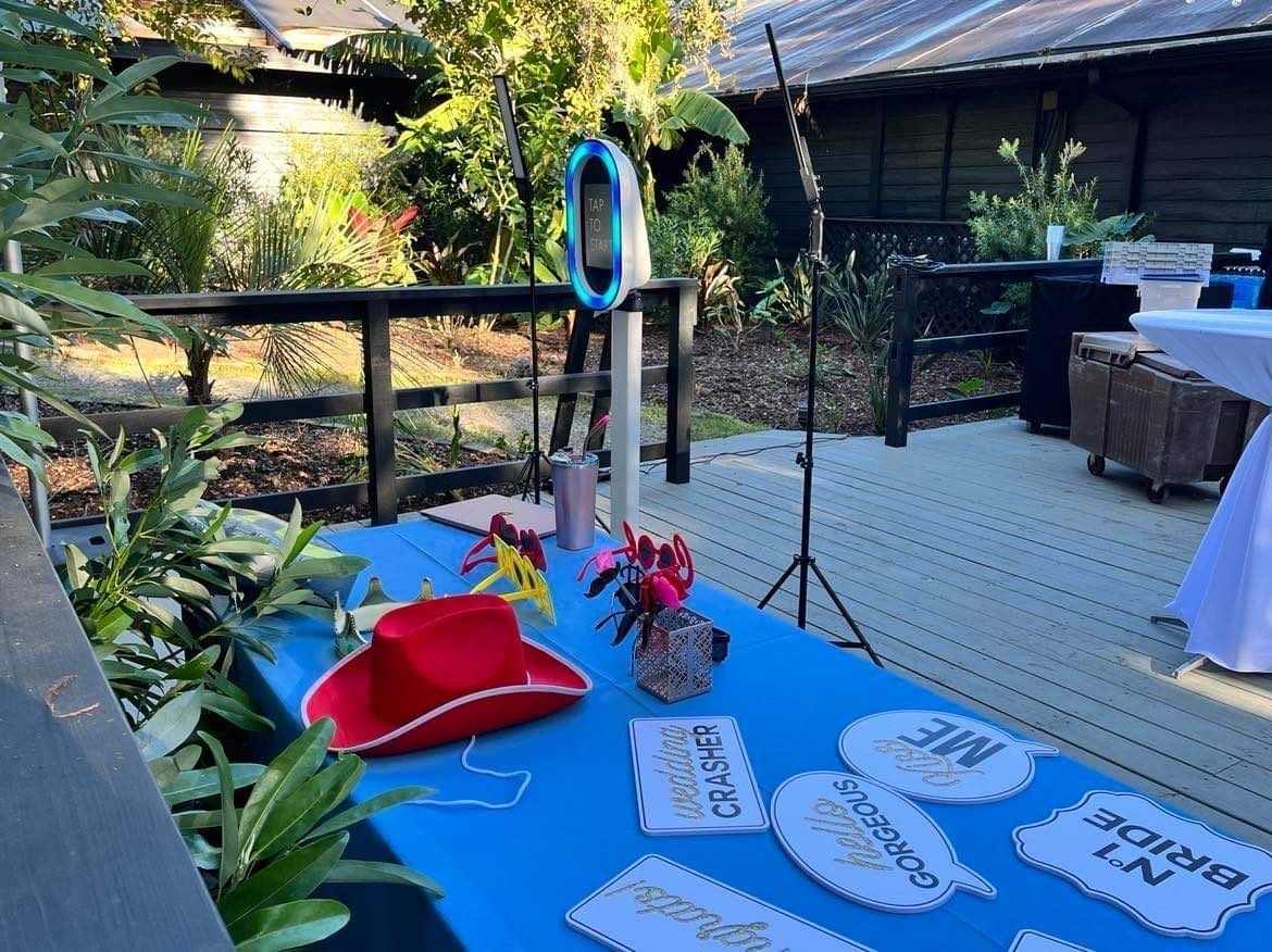 a table with a cowboy hat and a bride and groom sign on it .