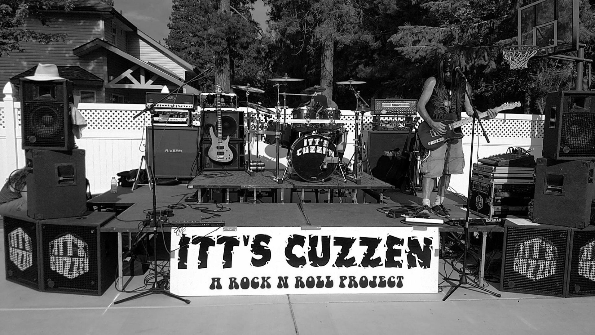 A band performs on an outdoor stage: 