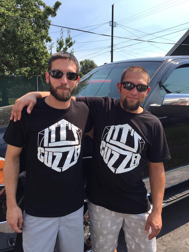 Two men wearing sunglasses and black 