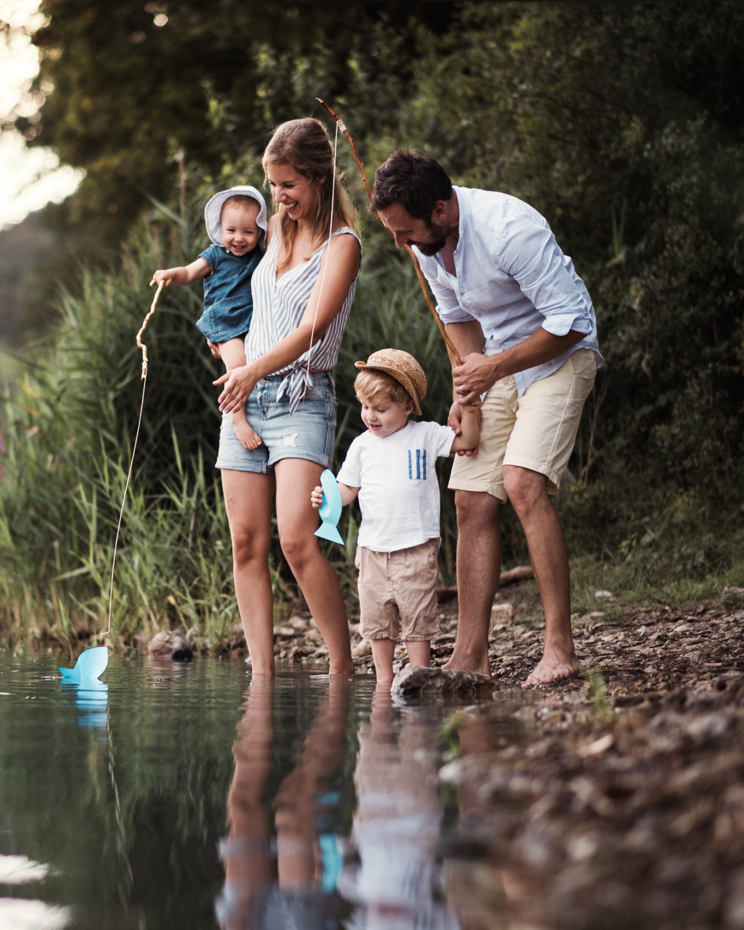A family is standing on the shore of a lake.
