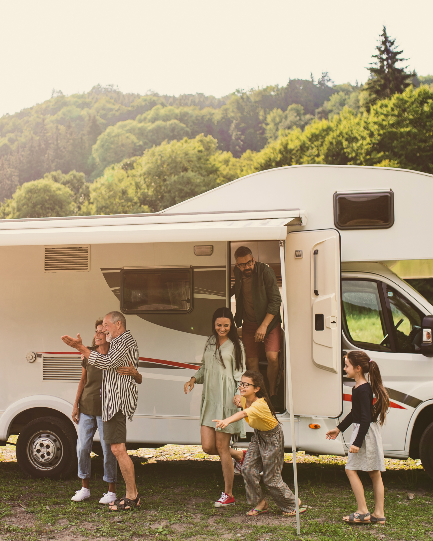 A family is standing in front of a rv.