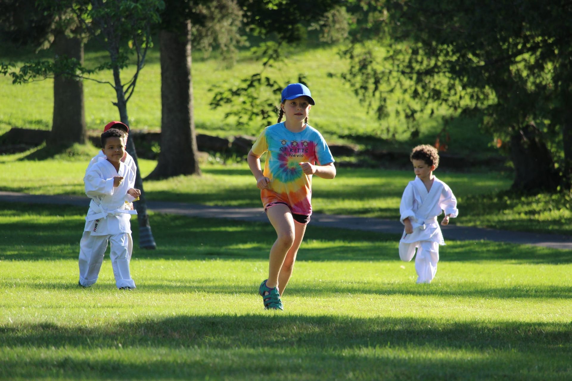 A group of children are running in a park.