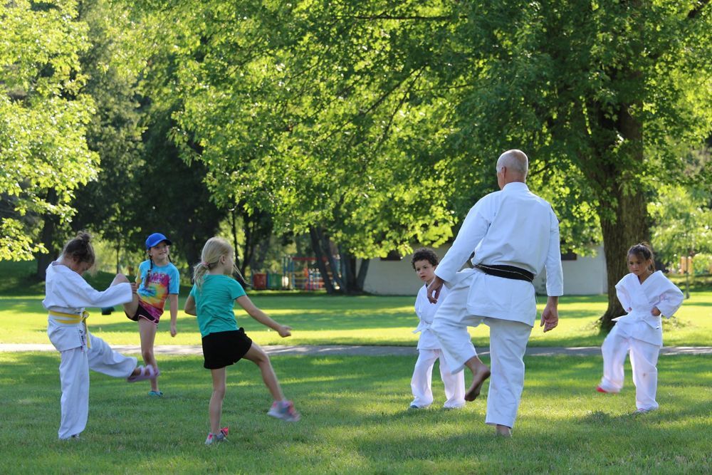 Kids Practicing Karate With Their Trainer