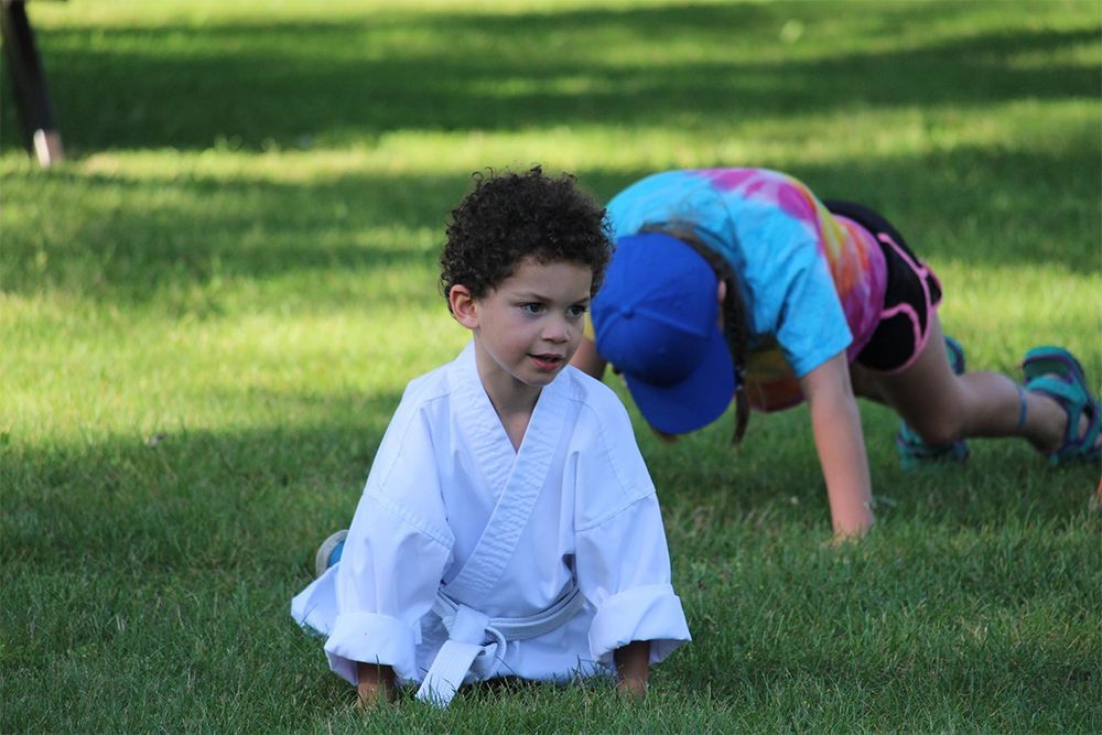 Kid Sitting On The Grass