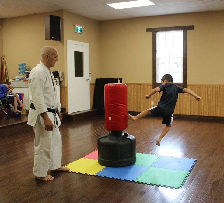 Kid Kicking The Practice Equipment