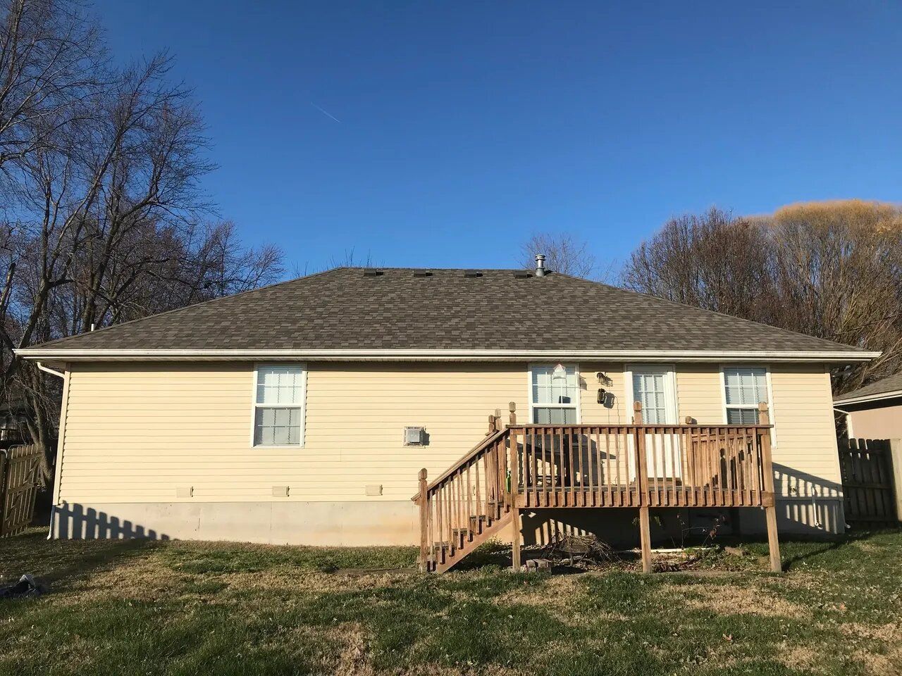 The back of a house with a deck and stairs.