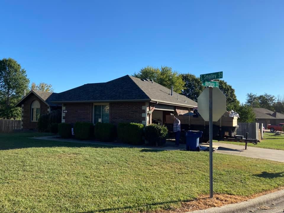 A house with a green street sign in front of it.