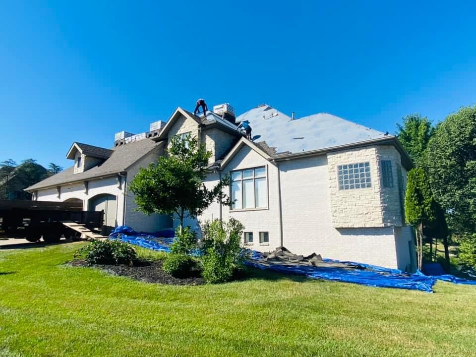 A large house with a truck parked in front of it is being remodeled.