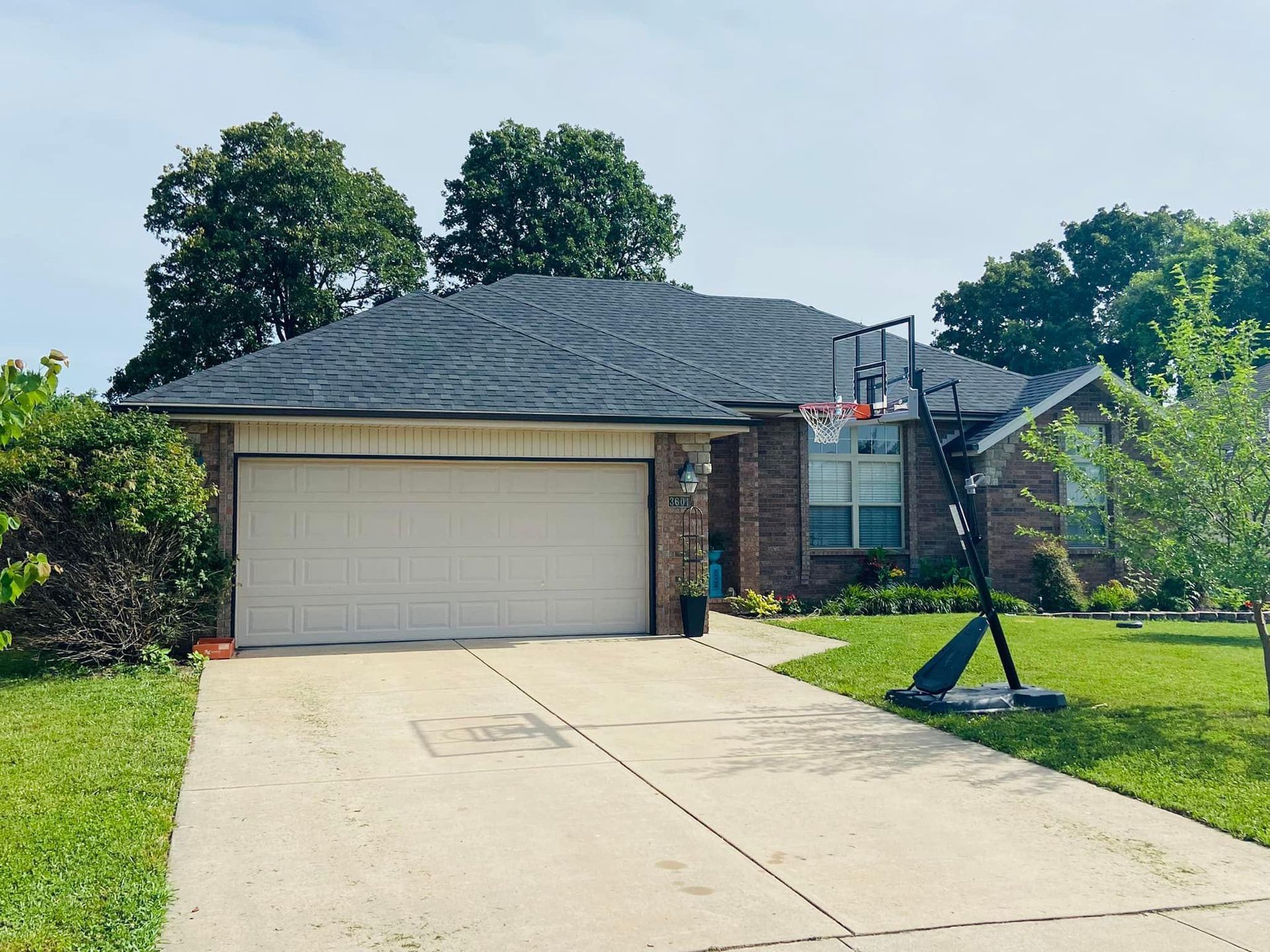A house with a basketball hoop in front of it.