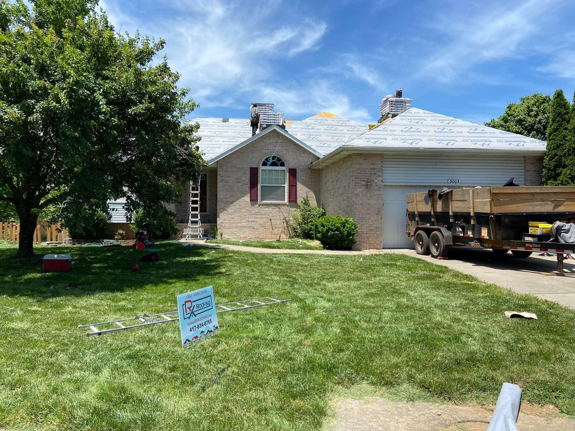 A house with a truck parked in front of it.