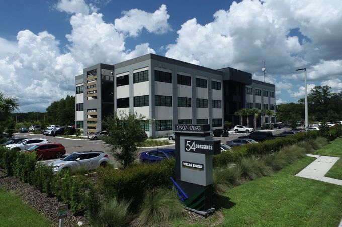 A large building with cars parked in front of it