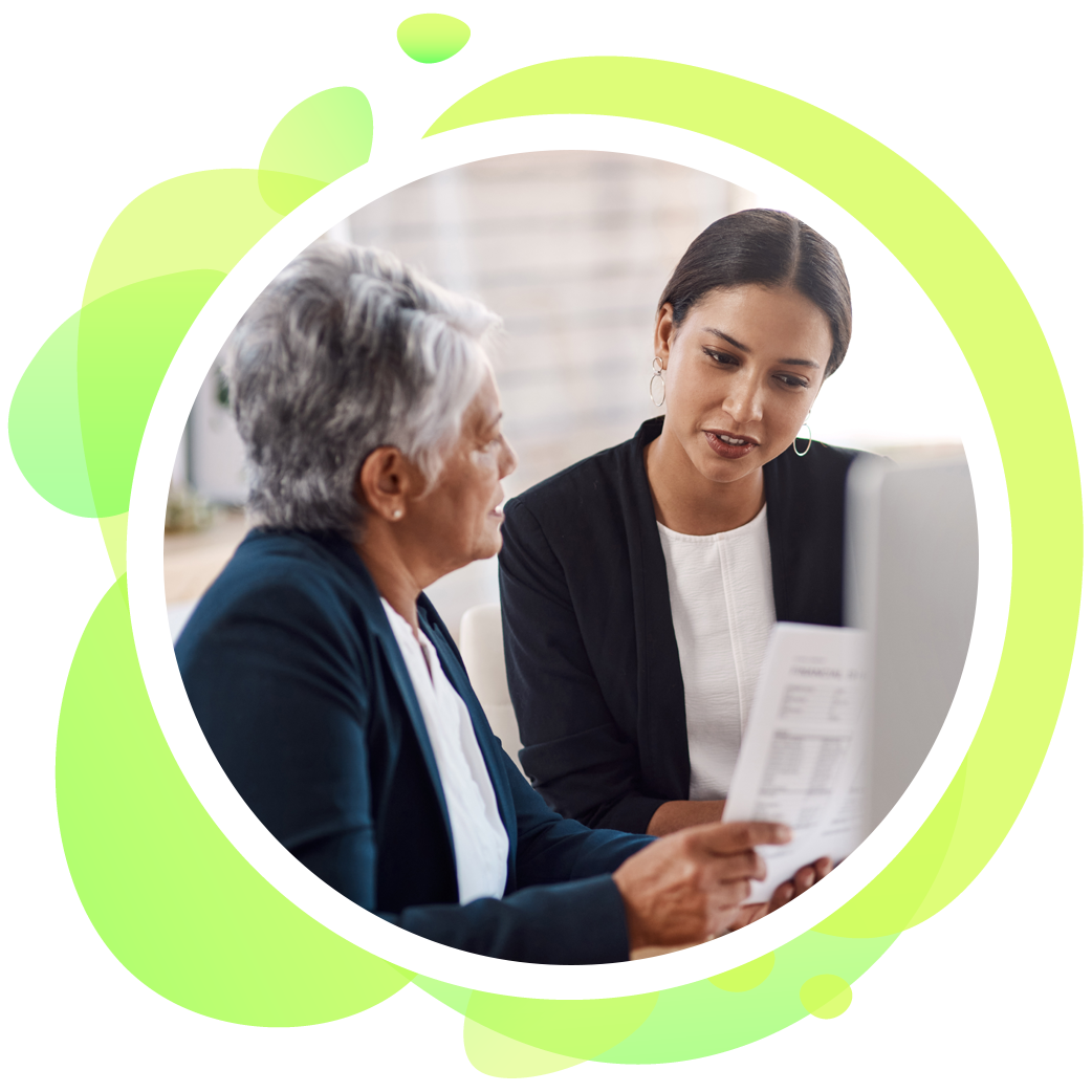 Two women are looking at a computer screen together.