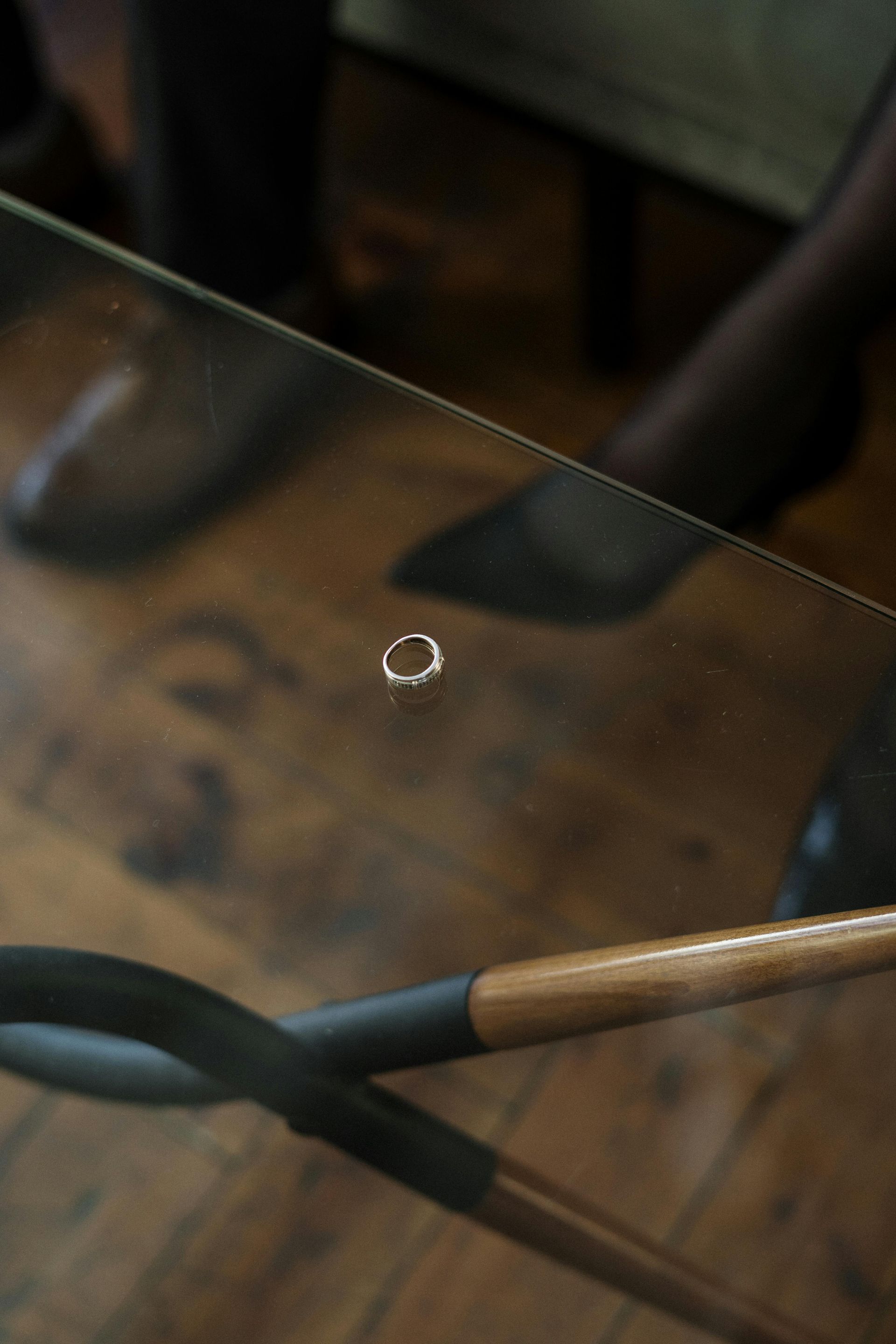 A woman is sitting on a couch taking off her wedding ring.