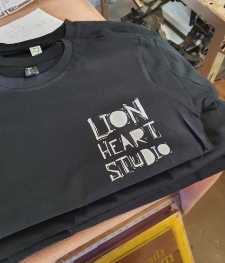 Folded Black T-Shirt With White Print — Printing in Coffs Harbour, NSW