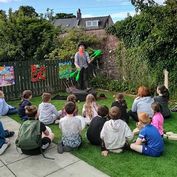 Mathew Kerr showing off his juggling skills in front of the kids at the Youth Hub