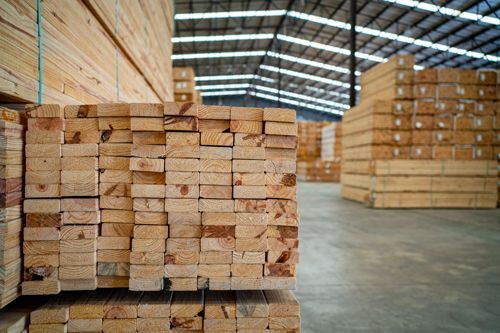 Stacks of hardwood planks in warehouse for commercial timber flooring supply and distribution