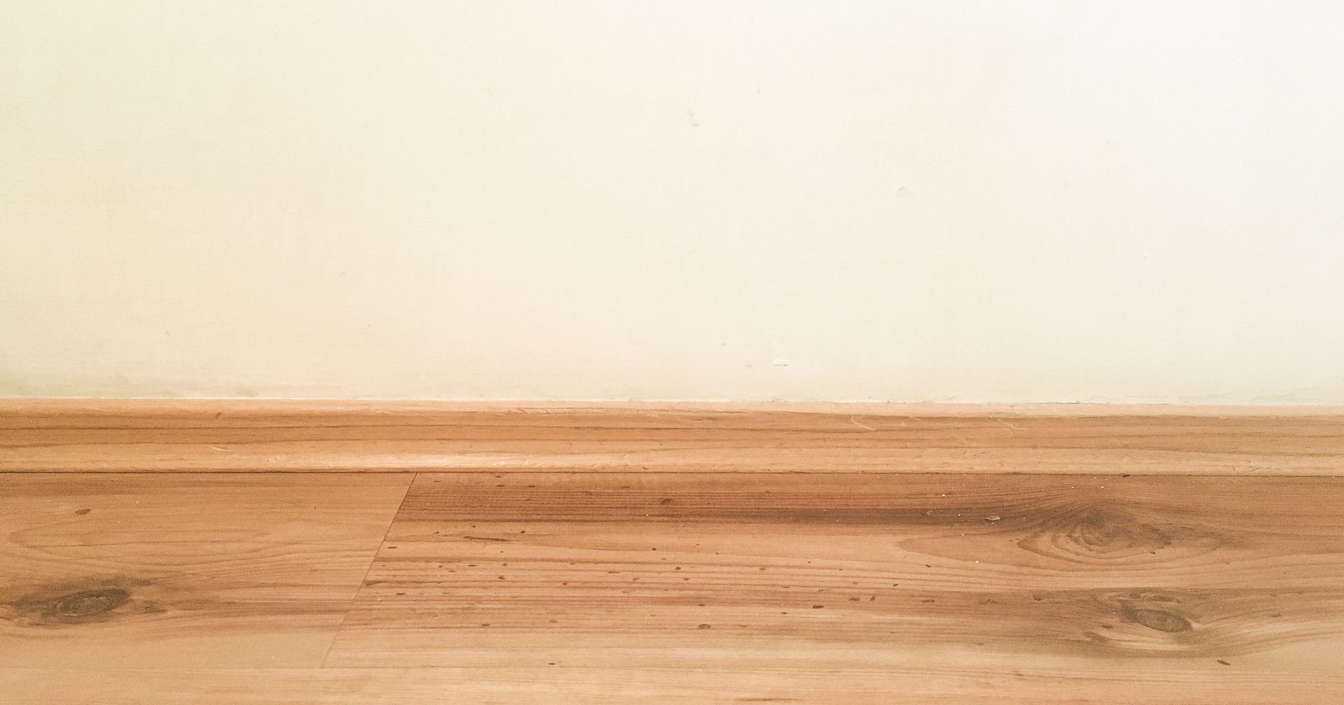 Wooden floor and white wall with watermark 
