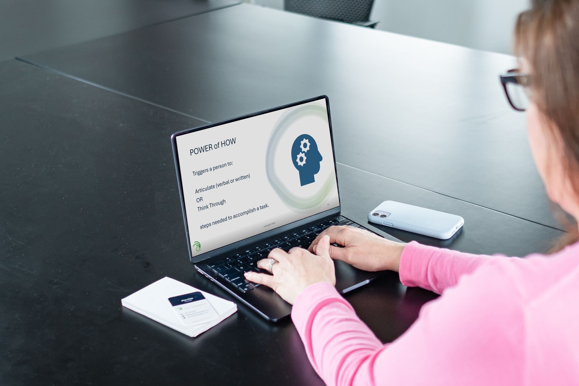 A hand is reflected in a broken mirror