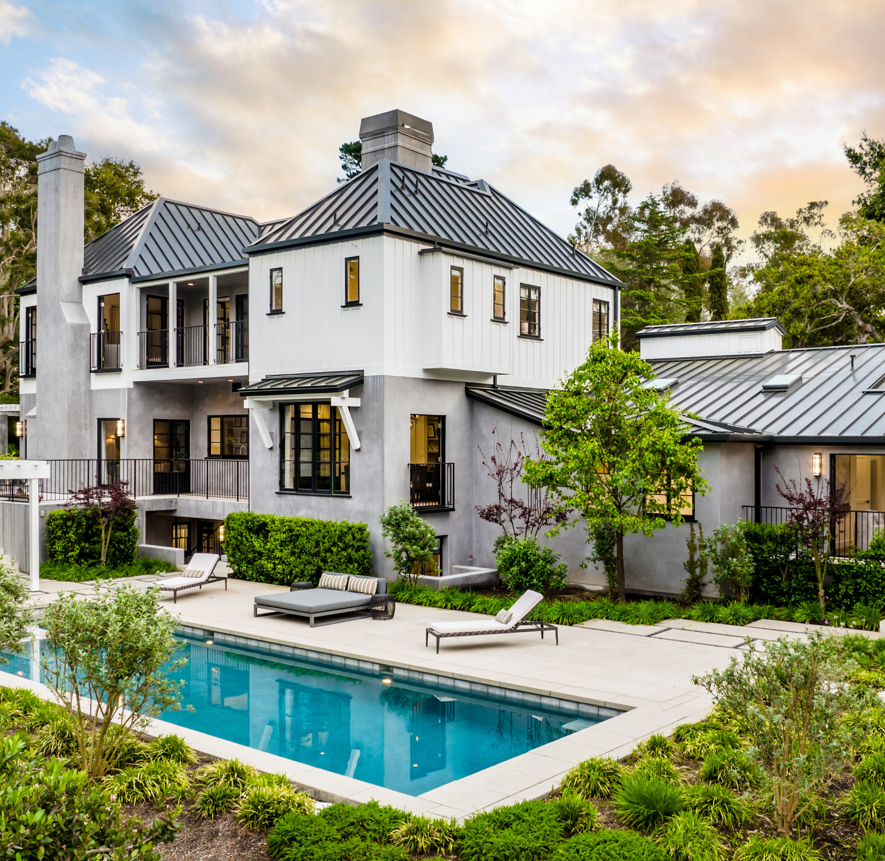 A large house with a large swimming pool in front of it