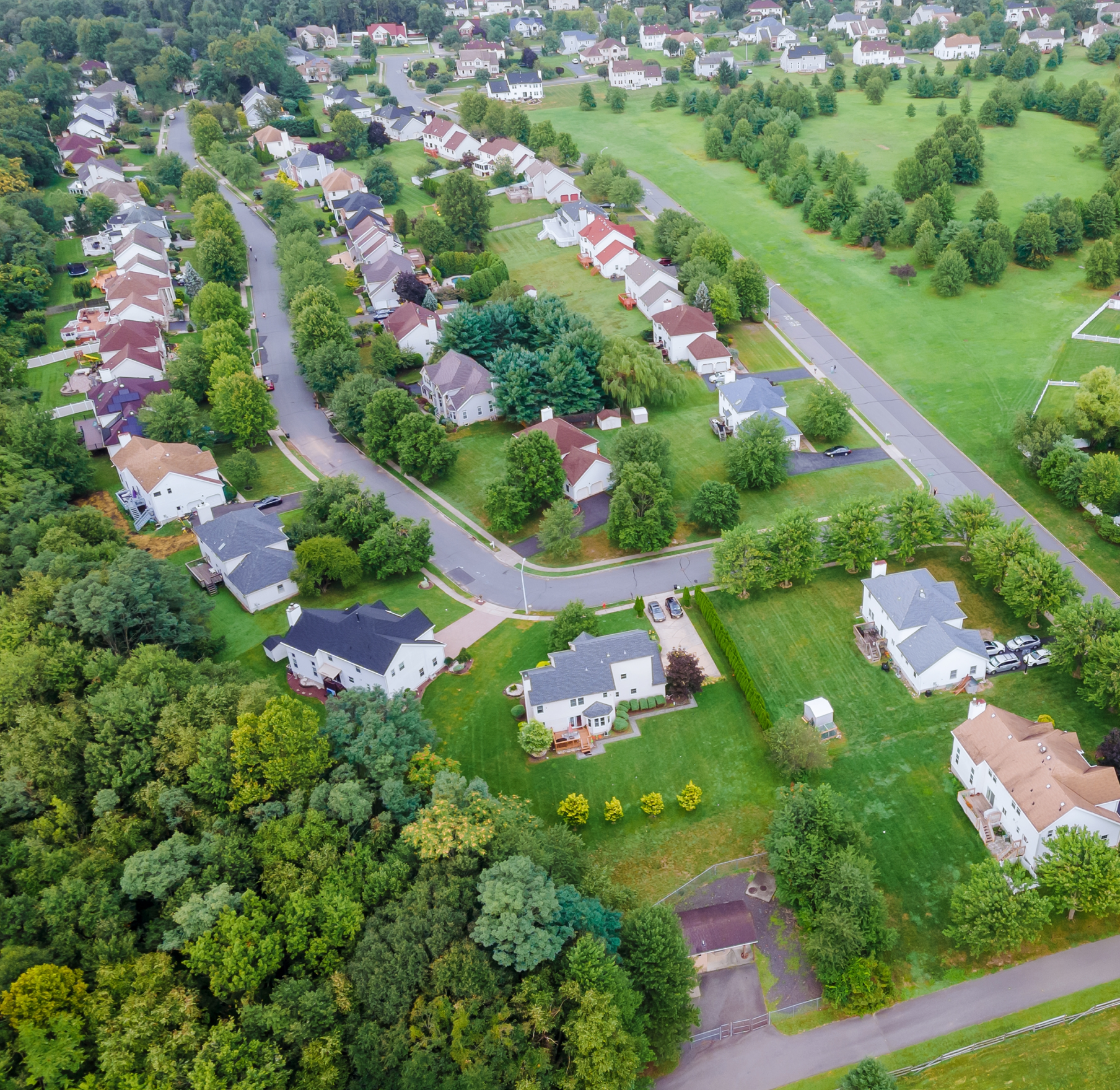 An aerial view of a residential area with lots of houses and trees