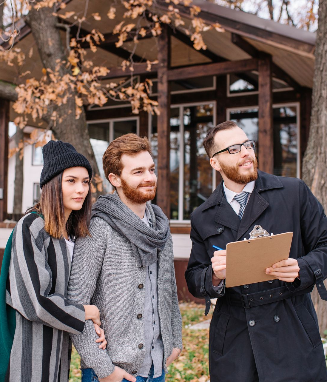 A man is holding a clipboard and a woman is standing next to him.