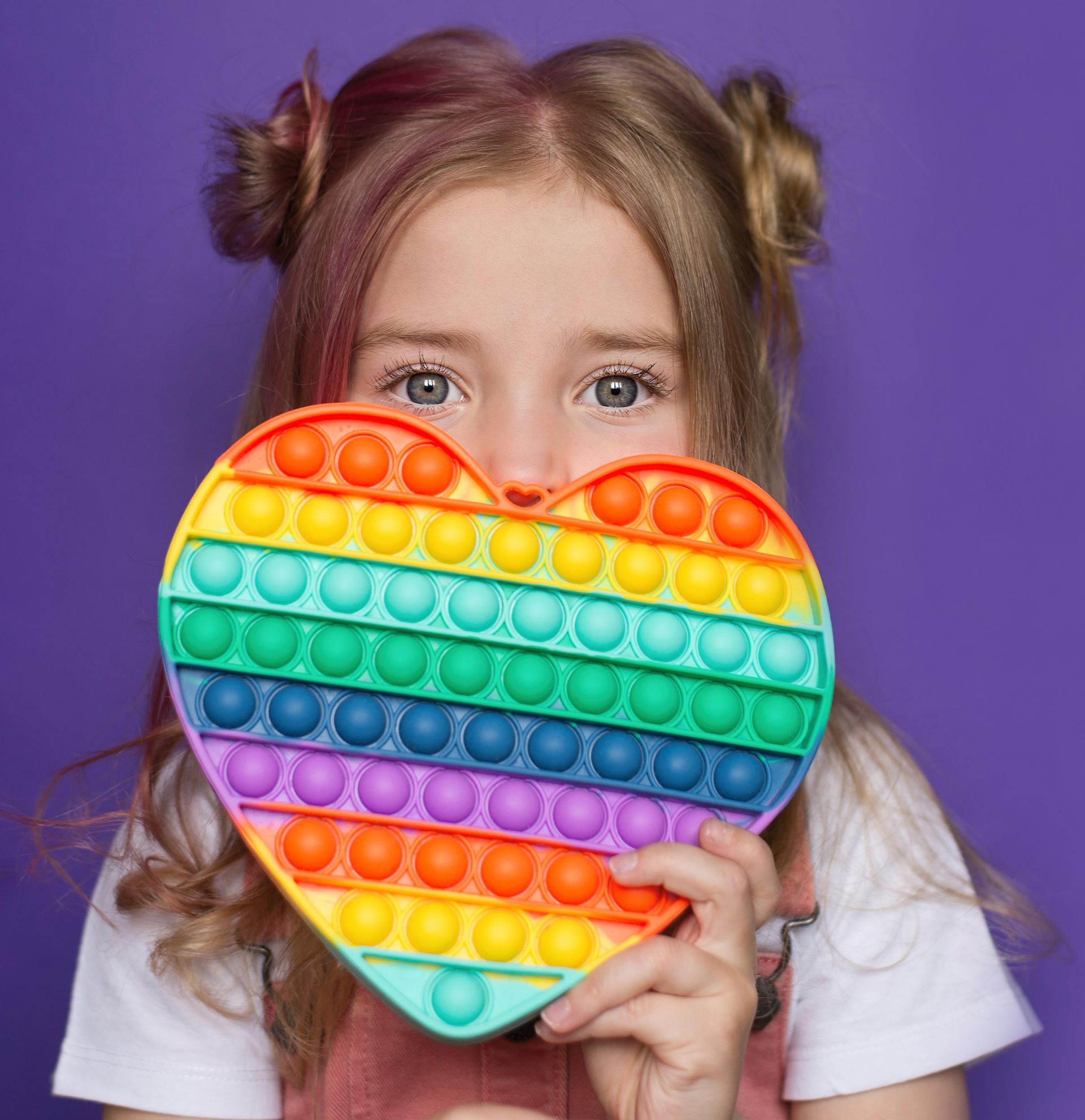 Little Girl Holding a Toy