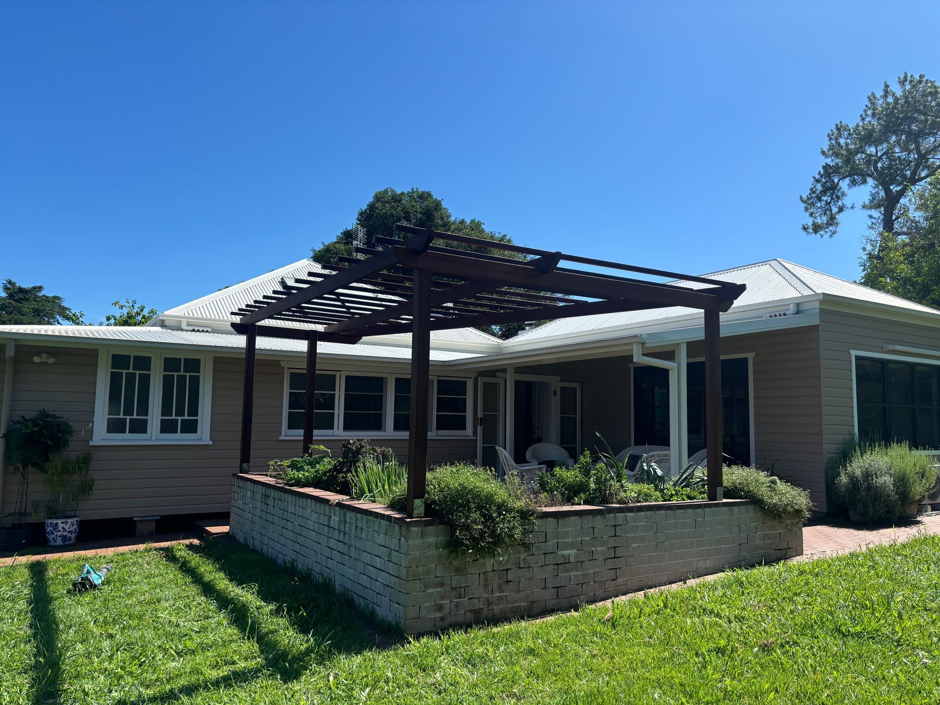 A house with a pergola and garden in the back garden — Tim Williams Landscapes in Lennox Head, NSW