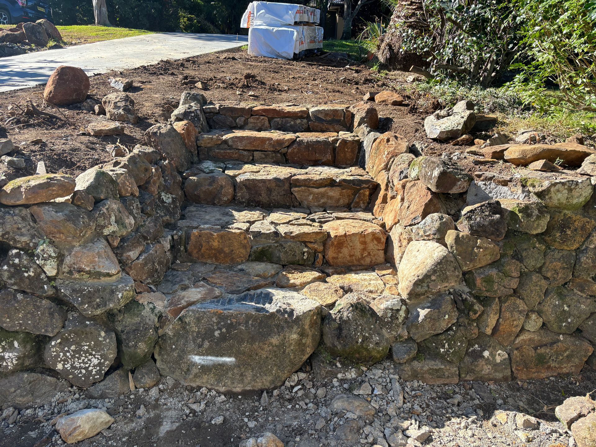 A retaining wall with steps is being built — Tim Williams Landscapes in Wollongbar, NSW