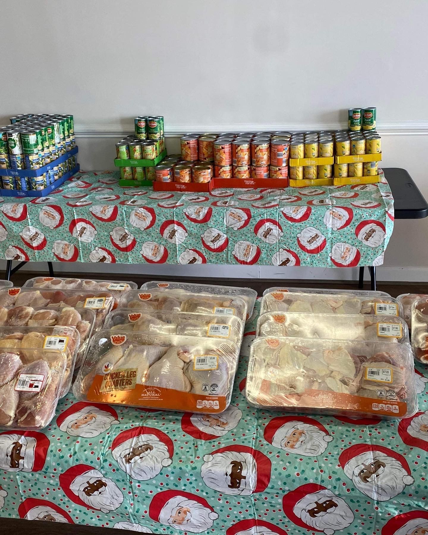 A table topped with trays of food and canned goods.