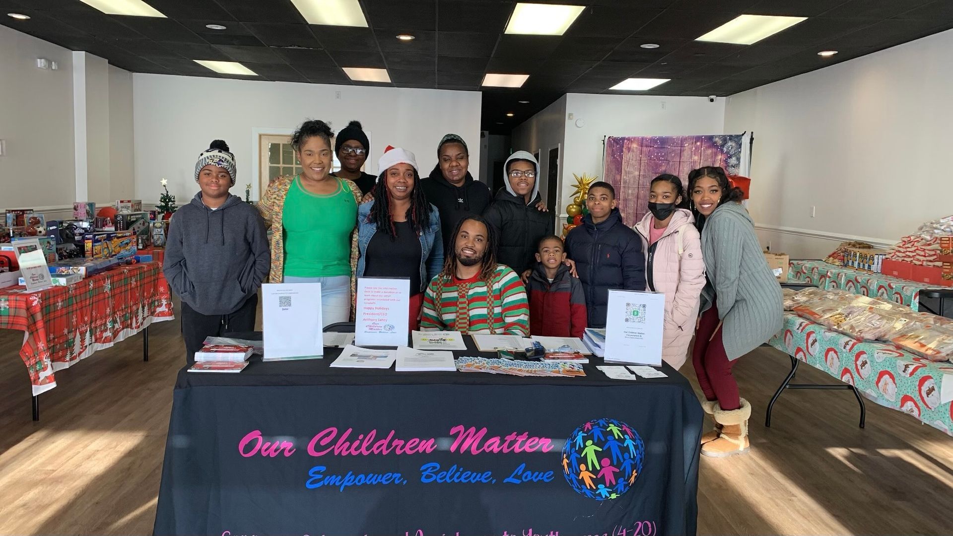 A group of people standing around a table in a room.
