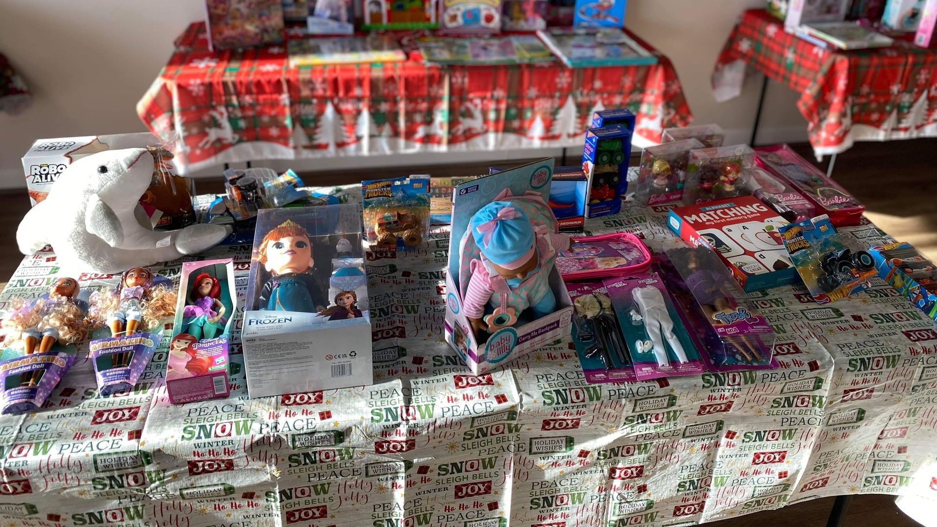 A table topped with lots of toys and books.