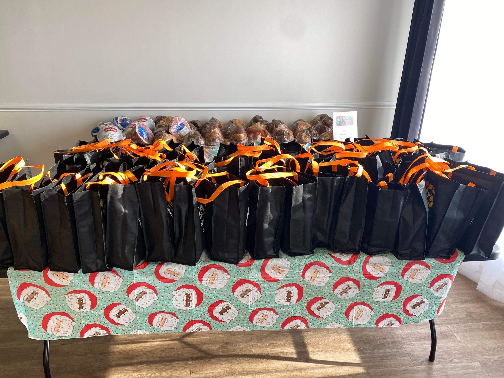 A table topped with lots of black bags and stuffed animals.