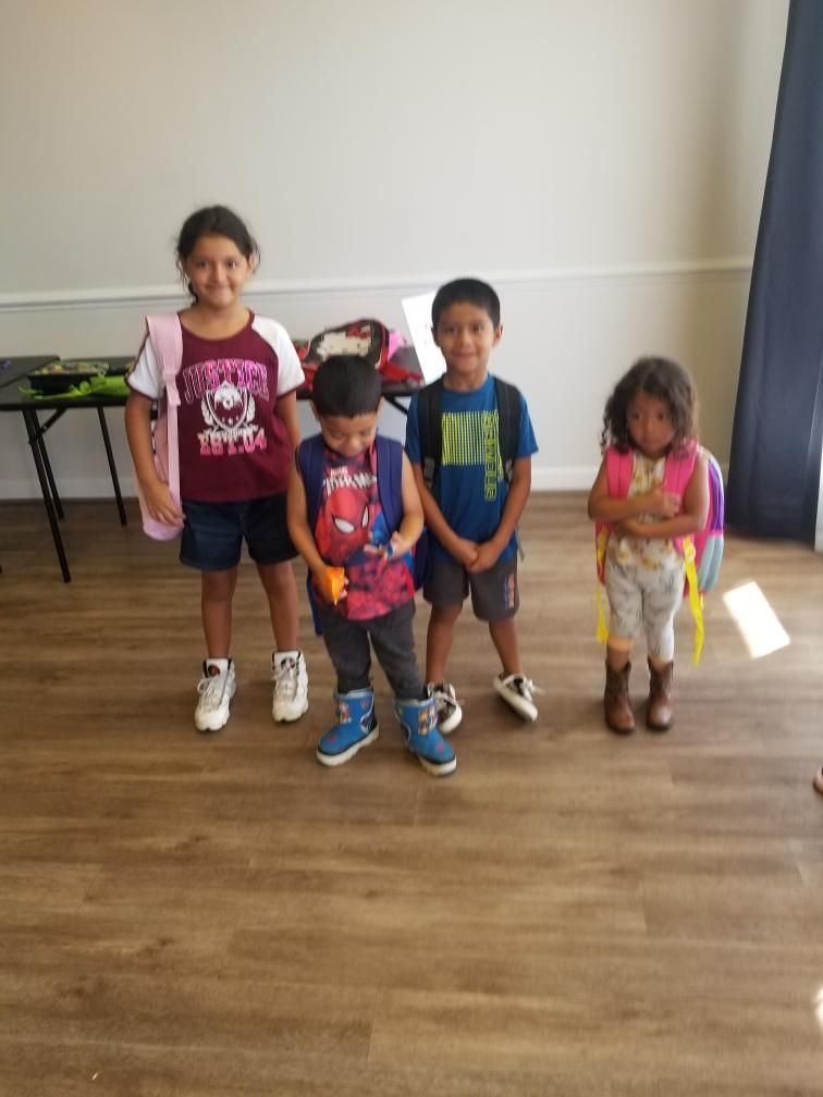 A group of children standing next to each other in a room.