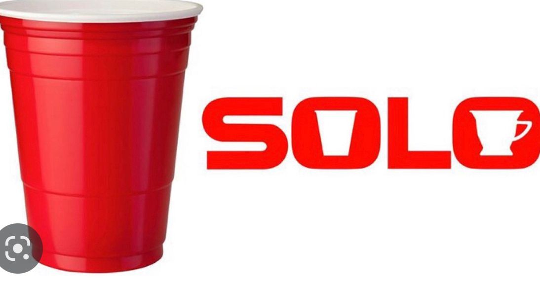 A red solo cup with a white lid on a white background