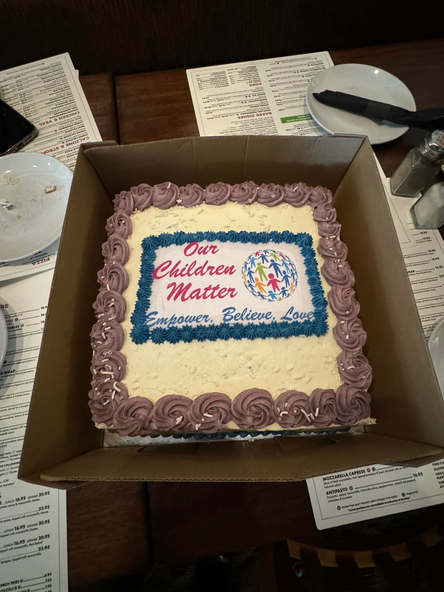 A cake in a box that says our children matter