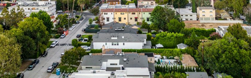 Aerial view of a residential neighborhood with streets, houses, and greenery.