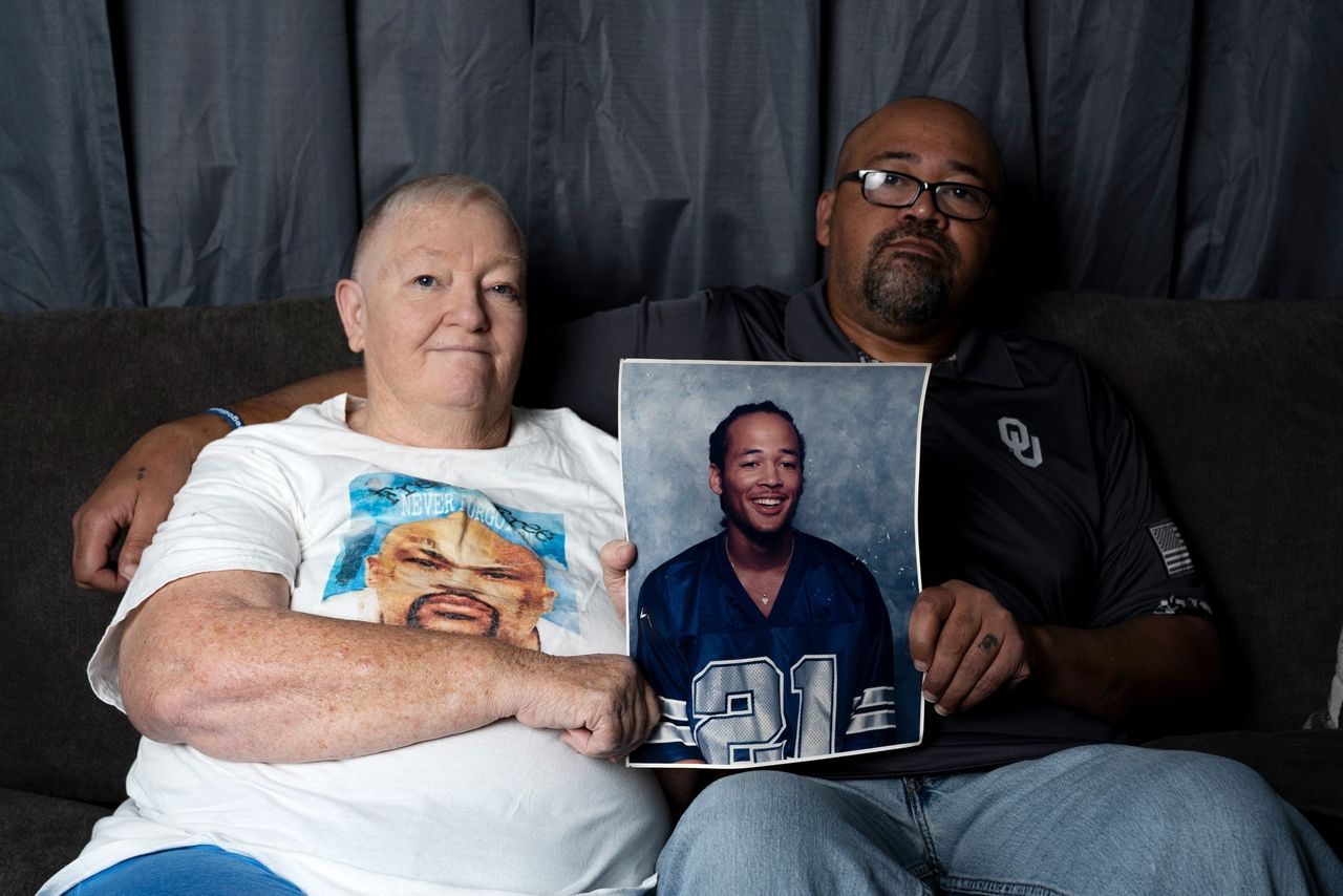 Linda Wood & her son Andre hold a photo of Linda's youngest son Tremane (Nick Oxford, Huff Post)